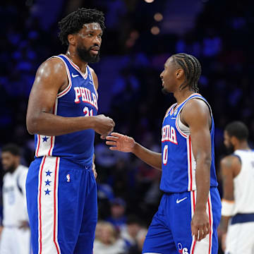 Feb 4, 2025; Philadelphia, Pennsylvania, USA; Philadelphia 76ers center Joel Embiid (21) reacts with guard Tyrese Maxey (0) against the Dallas Mavericks in the second quarter at Wells Fargo Center. Mandatory Credit: Kyle Ross-Imagn Images