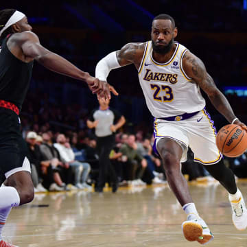Jan 21, 2024; Los Angeles, California, USA; Los Angeles Lakers forward LeBron James (23) moves the ball against Portland Trail Blazers forward Jerami Grant (9) during the second half at Crypto.com Arena. Mandatory Credit: Gary A. Vasquez-USA TODAY Sports