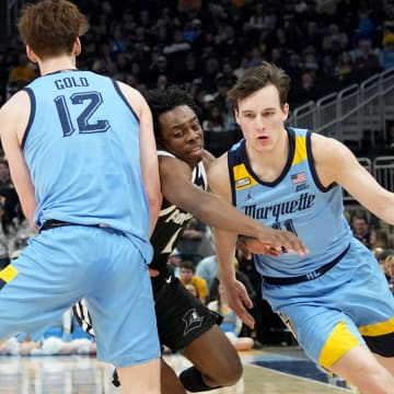 Marquette guard Tyler Kolek (11) takes advantage of a pick by forward Ben Gold (12) on guard Jayden Pierre (1) during the first half of their game Wednesday, February 28, 2024 at Fiserv Forum in Milwaukee, WisconsinMark Hoffman/Milwaukee Journal Sentinel