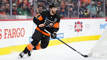 Mar 13, 2025; Philadelphia, Pennsylvania, USA; Philadelphia Flyers center Sean Couturier (14) controls the puck against the Tampa Bay Lightning in the first period at Wells Fargo Center. Mandatory Credit: Kyle Ross-Imagn Images