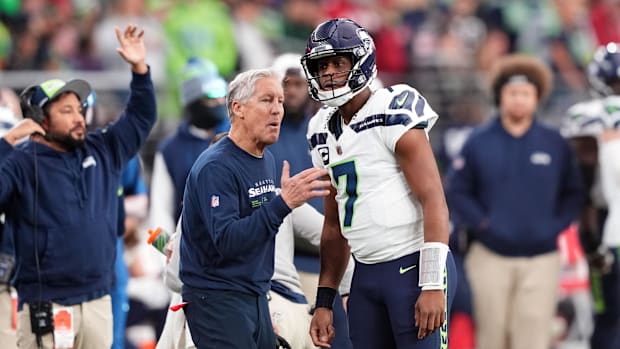 Seattle Seahawks head coach Pete Carroll talks with Seattle Seahawks quarterback Geno Smith against the Arizona Cardinals.