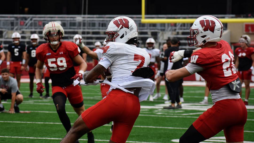 Wide receiver Shamar Rigby spins free from defenders. Wide receiver Shamar Rigby spins free from defenders.