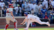 Apr 23, 2025; New York City, New York, USA; New York Mets first baseman Pete Alonso (20) scores the game winning run against Philadelphia Phillies catcher J.T. Realmuto (10) on a walkoff single by designated hitter Starling Marte (not pictured) during the tenth inning at Citi Field. Mandatory Credit: Brad Penner-Imagn Images