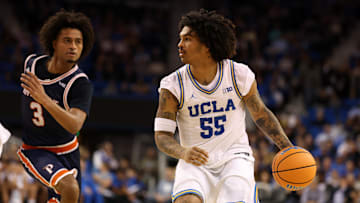 Nov 7, 2025; Los Angeles, California, USA;  UCLA Bruins guard Skyy Clark (55) dribbles the ball against Pepperdine Waves guard Aaron Clark (3) during the first half at Pauley Pavilion presented by Wescom Financial. Mandatory Credit: Kiyoshi Mio-Imagn Images