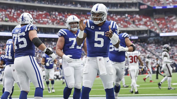 Indianapolis Colts quarterback Anthony Richardson celebrates after scoring a touchdown in a blue jersey.