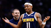 Oct 29, 2025; Denver, Colorado, USA; Denver Nuggets guard Bruce Brown (11) reacts as head coach David Adelman looks on in the fourth quarter against the New Orleans Pelicans at Ball Arena. Mandatory Credit: Isaiah J. Downing-Imagn Images