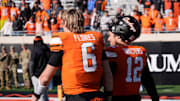 Oklahoma State's Zane Flores (6) and Noah Walters (12) walk of the field following the college football game between the Oklahoma State Cowboys and the Iowa State Cyclones at Boone Pickens Stadium in Stillwater, Okla., Saturday Nov. 29, 2025.