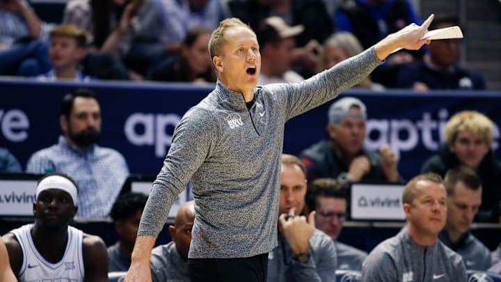 BYU head coach Kevin Young leads his team from the bench