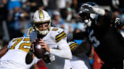 Nov 9, 2025; Charlotte, North Carolina, USA;  New Orleans Saints quarterback Tyler Shough (6) with the ball as Carolina Panthers defensive end Derrick Brown (95) pressures in the first quarter at Bank of America Stadium. Mandatory Credit: Bob Donnan-Imagn Images