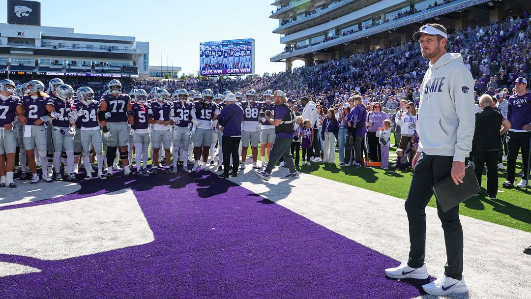 Oct 17, 2026; Manhattan, Kansas, USA;  Kansas State Wildcats head coach Collin Klein waits for his team to gather before going to the locker room following a win against the Kansas Jayhawks at Bill Snyder Family Football Stadium.  Mandatory Credit: Scott Sewell-Imagn Images