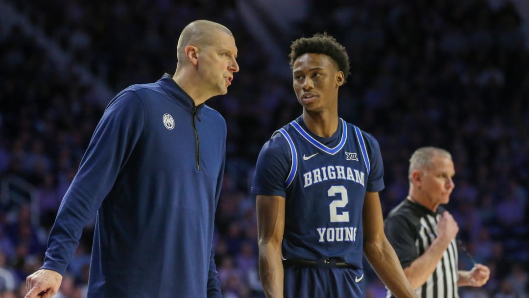 Feb 24, 2024; Manhattan, Kansas, USA; Brigham Young Cougars head coach Mark Pope talks to guard Jaxson Robinson (2) during a break in first-half action against the Kansas State Wildcats at Bramlage Coliseum. Mandatory Credit: Scott Sewell-USA TODAY Sports