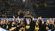 Iowa's women's wrestling team celebrates winning the team title on Saturday, March 9, 2024, at the NCWWCs at Alliant Energy PowerHouse in Cedar Rapids, Iowa.