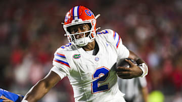 Nov 15, 2025; Oxford, Mississippi, USA; Florida Gators quarterback DJ Lagway (2) stiff-arms away from a tackle attempt against the Mississippi Rebels at Vaught-Hemingway Stadium. Mandatory Credit: Petre Thomas-Imagn Images