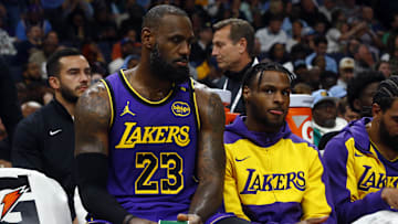Nov 6, 2024; Memphis, Tennessee, USA; Los Angeles Lakers forward LeBron James (23) and Los Angeles Lakers guard Bronny James (9) sit on the bench during the first half against the Memphis Grizzlies at FedExForum. Mandatory Credit: Petre Thomas-Imagn Images