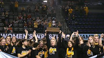 Iowa's women's wrestling team celebrates winning the team title on Saturday, March 9, 2024, at the NCWWCs at Alliant Energy PowerHouse in Cedar Rapids, Iowa.