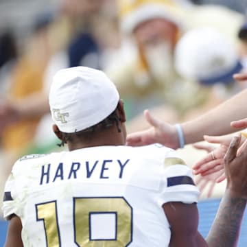 Nov 4, 2023; Charlottesville, Virginia, USA; Georgia Tech Yellow Jackets defensive back Ahmari Harvey (18) shakes hands with fans in the stands after defeating the Virginia Cavaliers at Scott Stadium. Mandatory Credit: Amber Searls-Imagn Images