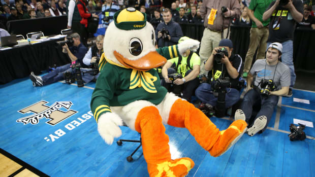 The Oregon Duck mascot steals a chair to clown around as the basketball team takes a commanding lead over Holy Cross