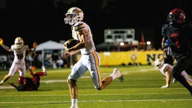 Carter Smith, the quarterback for the Bishop Verot football team runs for a touchdown during a game against the Cardinal Moon