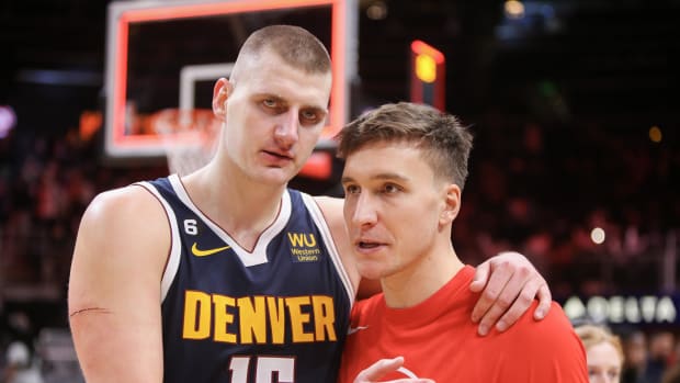 Denver Nuggets center Nikola Jokic talks to Atlanta Hawks guard Bogdan Bogdanovic