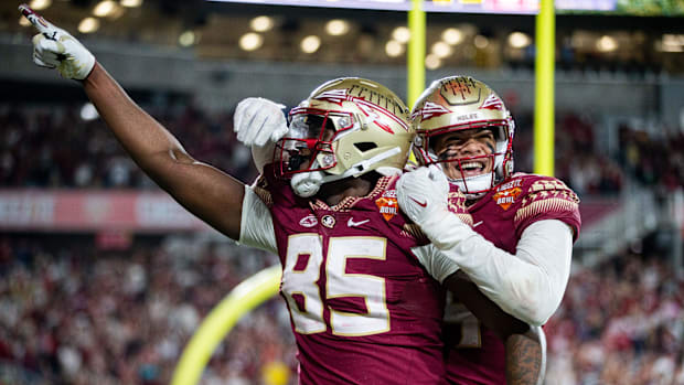 Florida State Seminoles tight end Markeston Douglas (85) and his teammate celebrate a touchdown.