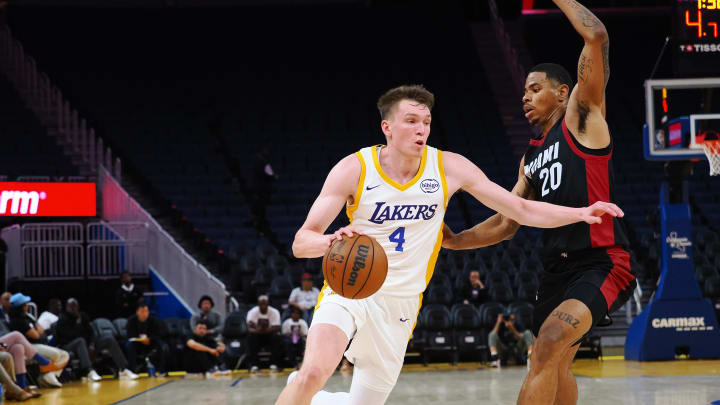 Jul 10, 2024; San Francisco, CA, USA; Los Angeles Lakers guard Dalton Knecht (4) drives against Miami Heat forward Keshad Johnson (20) during the third quarter at Chase Center. Mandatory Credit: Kelley L Cox-USA TODAY Sports