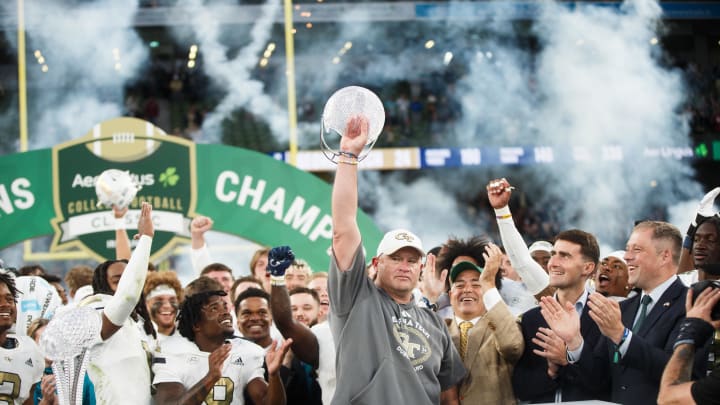 Aug 24, 2024; Dublin, IRL; Georgia Tech head coach Brent Key celebrates with the coachís award after their win against Florida State at Aviva Stadium. Mandatory Credit: Tom Maher/INPHO via USA TODAY Sports