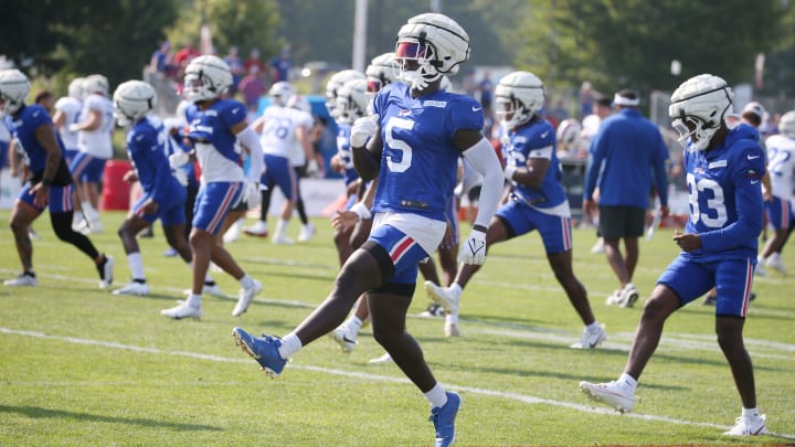 Bills defensive back Kaiir Elam high steps as he warms up.