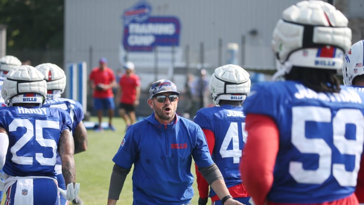 Bills defensive coordinator Bobby Babich pumps up the defensive squad as they head to the back field for drills.