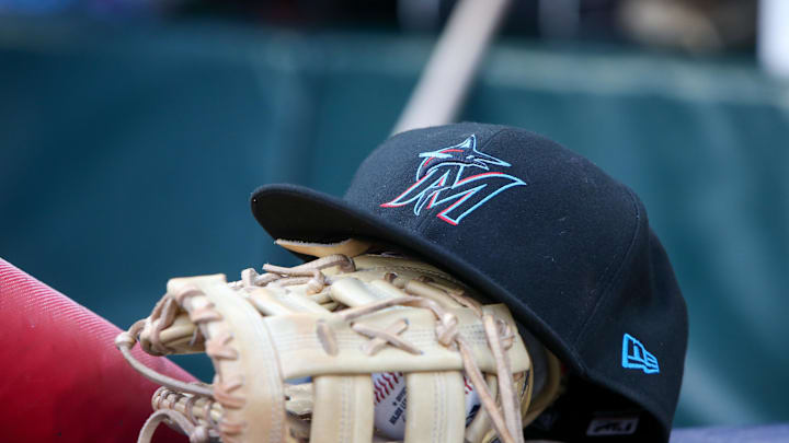 Apr 24, 2024; Atlanta, Georgia, USA; A detailed view of a Miami Marlins hat and glove in the dugout before a game against the Atlanta Braves at Truist Park. Mandatory Credit: Brett Davis-Imagn Images Apr 24, 2024; Atlanta, Georgia, USA; A detailed view of a Miami Marlins hat and glove in the dugout before a game against the Atlanta Braves at Truist Park. Mandatory Credit: Brett Davis-Imagn Images