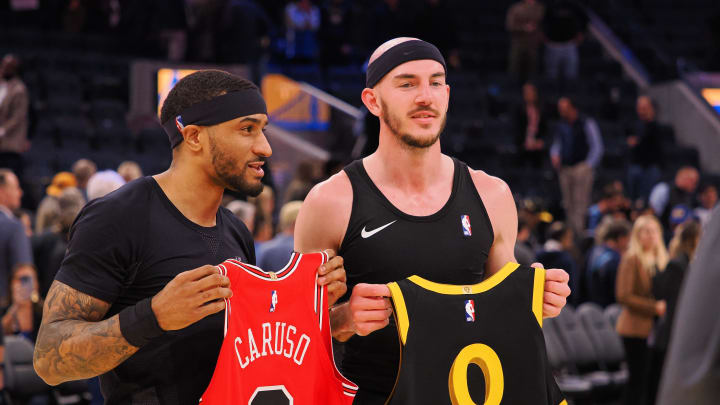 Mar 7, 2024; San Francisco, California, USA; Golden State Warriors guard Gary Payton II (0) and Chicago Bulls forward Alex Caruso (6) exchange jerseys after the game at Chase Center. 