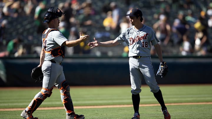 Sep 8, 2024; Oakland, California, USA; Detroit Tigers catcher Jake Rogers (34) and pitcher Kenta Maeda (18) celebrate their 9-1 victory over the Oakland Athletics at Oakland-Alameda County Coliseum.