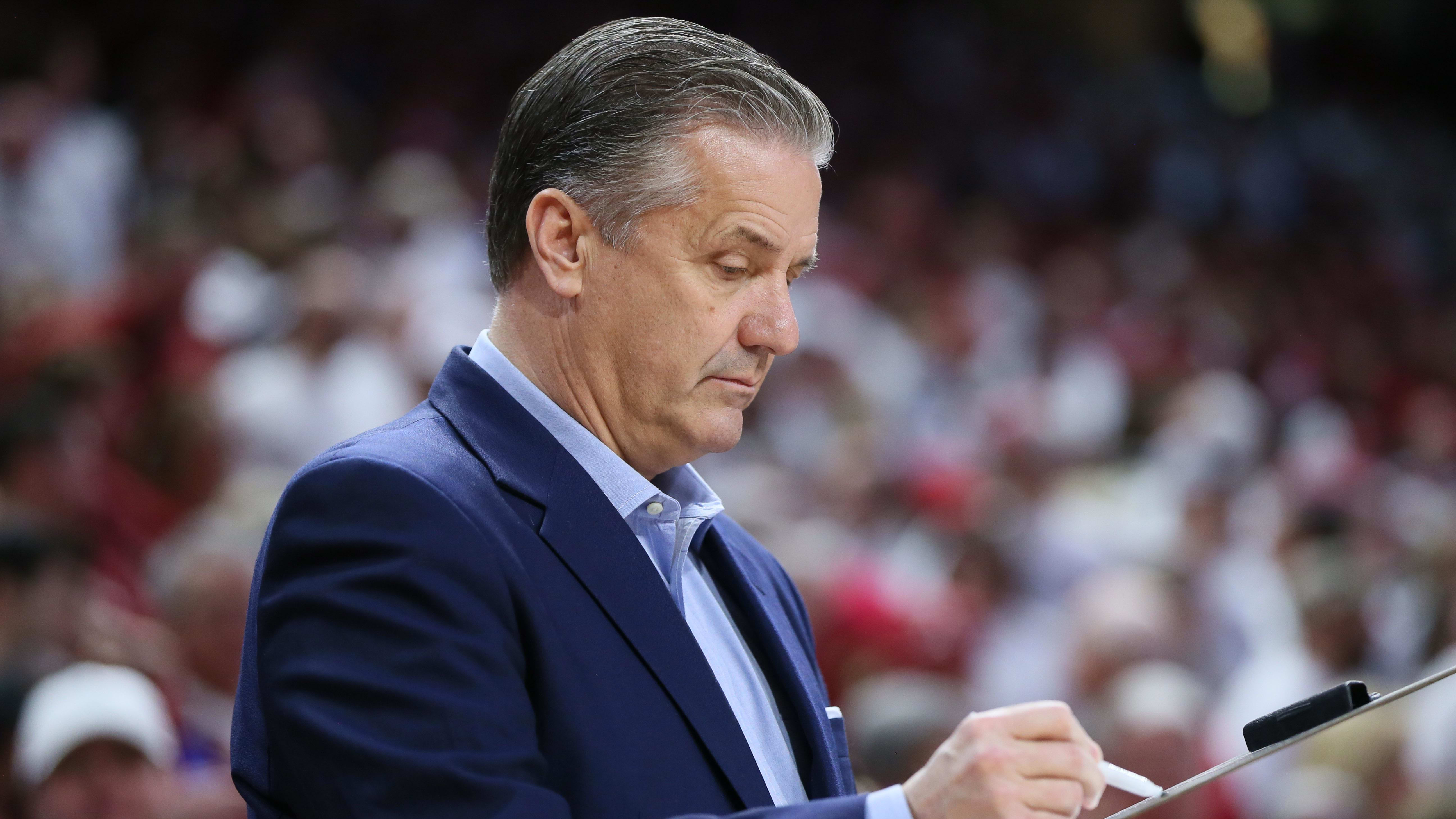 Kentucky Wildcats head coach John Calipari marks on his clipboard prior to the game.