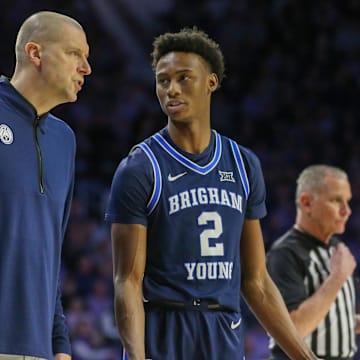 Feb 24, 2024; Manhattan, Kansas, USA; Brigham Young Cougars head coach Mark Pope talks to guard Jaxson Robinson (2) during a break in first-half action against the Kansas State Wildcats at Bramlage Coliseum. Mandatory Credit: Scott Sewell-Imagn Images