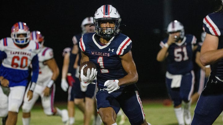 Malik Allen of the Estero High School football team gains yards against Cape Coral High School on Friday, Sept. 22, 2023. Estero won 38-0. He returns in 2024 after rushing for 1,293 yards and 10 TDs last year.