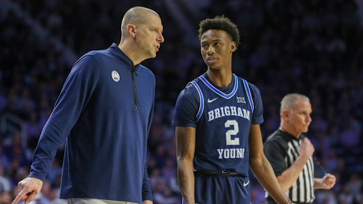 Feb 24, 2024; Manhattan, Kansas, USA; Brigham Young Cougars head coach Mark Pope talks to guard Jaxson Robinson (2) during a break in first-half action against the Kansas State Wildcats at Bramlage Coliseum. Mandatory Credit: Scott Sewell-Imagn Images