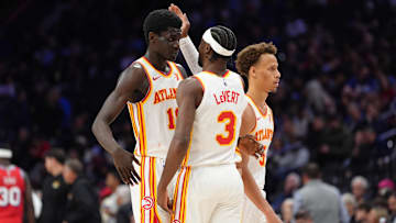Mouhamed Gueye #10, Caris LeVert #3, Dyson Daniels #5 of the Atlanta Hawks react against the Philadelphia 76ers.
