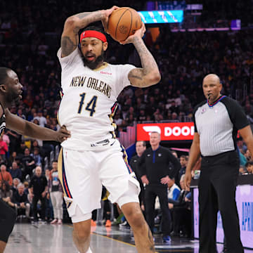 Mar 28, 2023; San Francisco, California, USA; New Orleans Pelicans small forward Brandon Ingram (14) controls the ball against Golden State Warriors center Draymond Green (23) during the fourth quarter at Chase Center. 