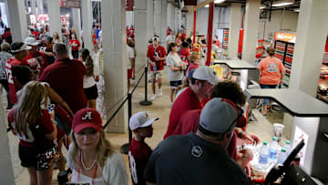 Fans purchase food and drink at one of the concession vendors inside Bryant-Denny Stadium.