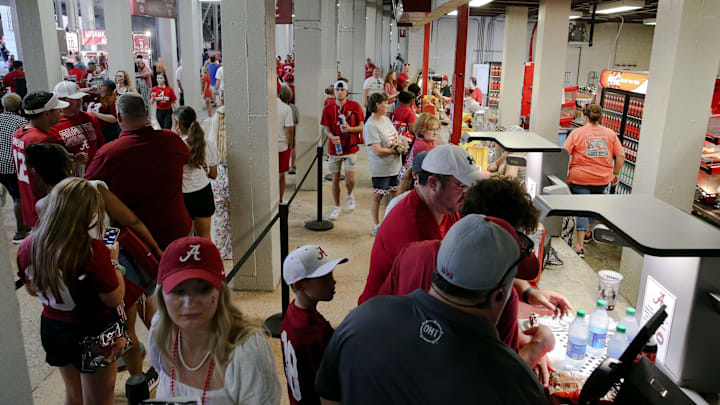 Fans purchase food and drink at one of the concession vendors inside Bryant-Denny Stadium. Fans purchase food and drink at one of the concession vendors inside Bryant-Denny Stadium.