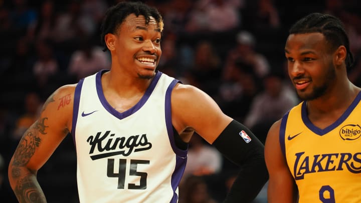 Jul 6, 2024; San Francisco, CA, USA; Sacramento Kings guard Adonis Arms (45) smiles with Los Angeles Lakers guard Bronny James Jr. (9) as they line up for. aLaker free throw during the fourth quarter at Chase Center. Mandatory Credit: Kelley L Cox-USA TODAY Sports