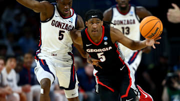 Mar 20, 2025; Wichita, KS, USA; Georgia Bulldogs guard Silas Demary Jr. (5) dribbles against Gonzaga Bulldogs forward Emmanuel Innocenti (5) in the second half of a first round men’s NCAA Tournament game at Intrust Bank Arena. Mandatory Credit: Nick Tre. Smith-Imagn Images