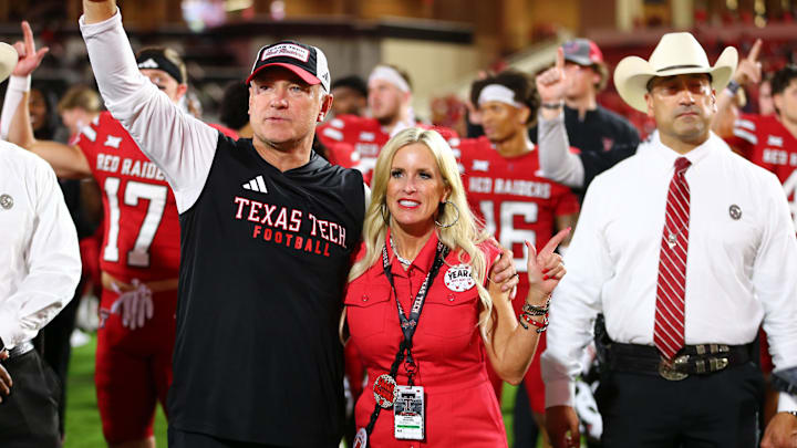 Aug 30, 2025; Lubbock, Texas, USA;  Texas Tech Red Raiders head coach Joey McGuire and wife Debbie sing the school song after the game against the Arkansas-Pine Bluff Golden Lions at Jones AT&T Stadium. Mandatory Credit: Michael C. Johnson-Imagn Images