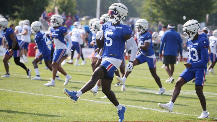 Bills defensive back Kaiir Elam high steps as he warms up.