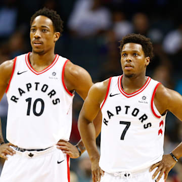 Feb 11, 2018; Charlotte, NC, USA; Toronto Raptors guard Kyle Lowry (7) and guard DeMar DeRozan (10) stands on the court in the first half against the Charlotte Hornets at Spectrum Center. Mandatory Credit: Jeremy Brevard-Imagn Images