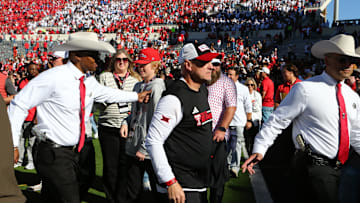 Nov 8, 2025; Lubbock, Texas, USA;  Texas Tech Red Raiders head coach Joey McGuire is escorted off the field after fans stormed the field at the conclusion of the game against the Brigham Young Cougars at Jones AT&T Stadium. Mandatory Credit: Michael C. Johnson-Imagn Images
