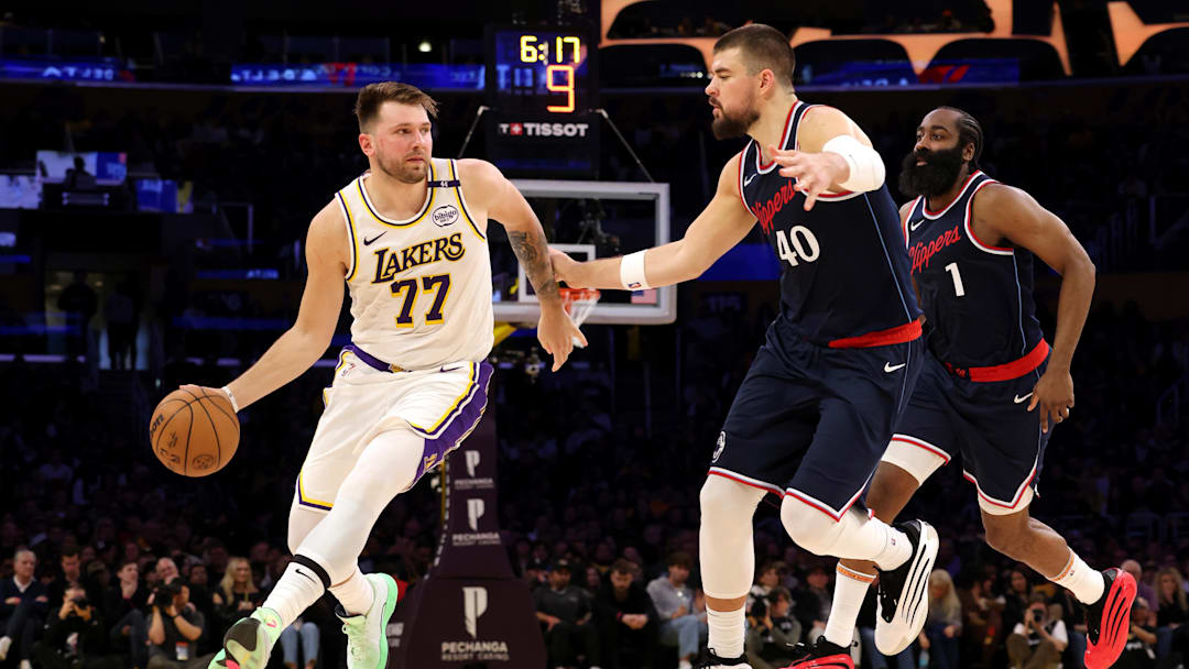 Mar 2, 2025; Los Angeles, California, USA: Los Angeles Lakers guard Luka Doncic (77) dribbles against LA Clippers center Ivica Zubac (40) and guard James Harden (1) during the second quarter at Crypto.com Arena. Mandatory Credit: Jason Parkhurst-Imagn Images