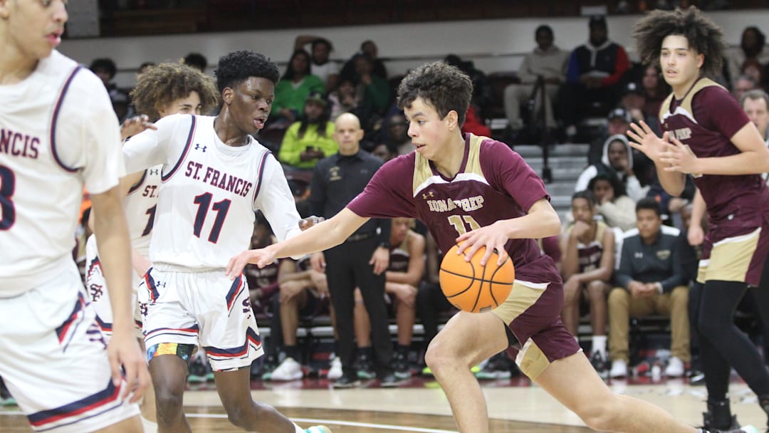 Iona Prep's Lucas Morillo (11, red) tries to drive past St. Francis Prep's Nigel Moore (11, white) during the CHSAA AA city quarterfinals at Fordham University on March 5, 2023.

Img 1710