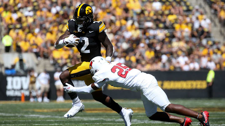 Iowa’s Kaleb Johnson (2) tries to evade the tackle by Illinois State’s Cam Wilson (25) Saturday, Aug. 31, 2024 at Kinnick Stadium in Iowa City, Iowa.