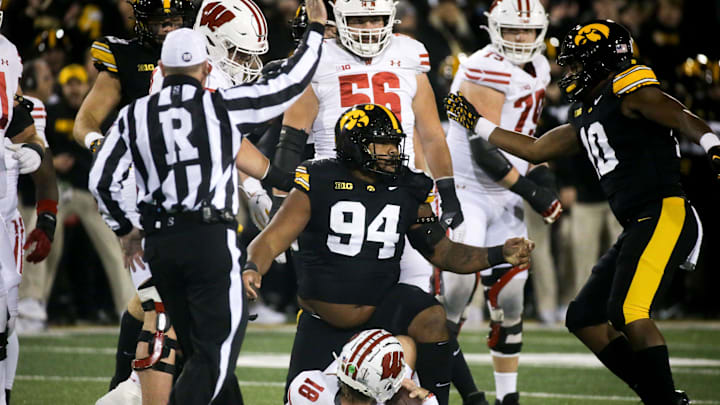 Iowa defensive lineman Yahya Black (94) tackled Wisconsin quarterback Braedyn Locke (18) in the Saturday, Nov. 2, 2024 at Kinnick Stadium in Iowa City, Iowa.