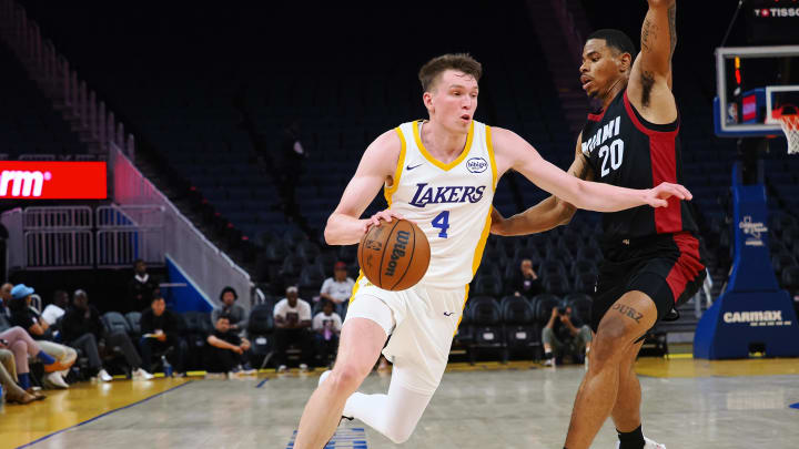 Jul 10, 2024; San Francisco, CA, USA; Los Angeles Lakers guard Dalton Knecht (4) drives against Miami Heat forward Keshad Johnson (20) during the third quarter at Chase Center. Mandatory Credit: Kelley L Cox-USA TODAY Sports